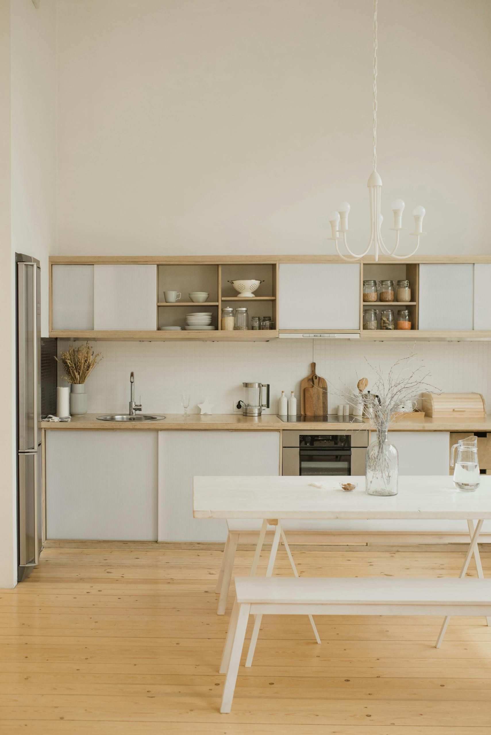 Stylish kitchen interior with minimalistic design and modern wooden elements.